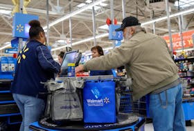 A customer bags his groceries after shopping at a Walmart store ahead of the Thanksgiving holiday in Chicago, Illinois, U.S. November 27, 2019.