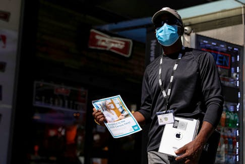 A U.S. Census worker waits to take information from people during a promotional event in Times Square in New York City, New York, U.S., September 23, 2020.