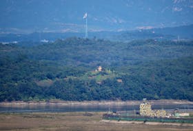 South and North Korean guard posts face each other as a South Korean national flag flutters in this picture taken from the Unification Observation Platform, near the demilitarized zone which separates the two Koreas in Paju, South Korea, October 6, 2022.