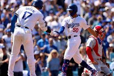 Mar 28, 2024; Los Angeles, California, USA; Los Angeles Dodgers outfielder Mookie Betts (50) celebrates with designated hitter Shohei Ohtani (17) after hitting a home run during the third inning of an opening day game against the St. Louis Cardinals at Dodger Stadium. Mandatory Credit: Jason Parkhurst-USA TODAY Sports