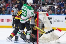 Dallas Stars' Wyatt Johnston (53) collides with Vancouver Canucks goalie Casey DeSmith and is given a goalie interference penalty during the first period of an NHL hockey game in Vancouver, on Thursday, March 28, 2024.