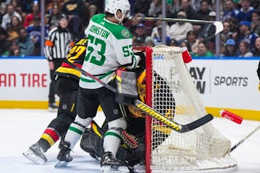 Dallas Stars' Wyatt Johnston collides with Canucks goalie Casey DeSmith and is given a goalie interference penalty during an NHL game in Vancouver on March 28.