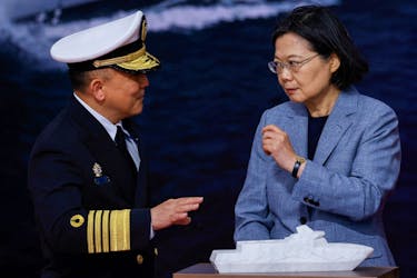 Taiwan President Tsai Ing-wen speaks with Taiwan Navy Commander Tang Hua at the delivery ceremony of six made-in-Taiwan Tuo Chiang-class corvettes at a port in Yilan, Taiwan March 26, 2024.