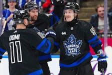Toronto Maple Leafs left wing Tyler Bertuzzi (59) celebrates his goal against the Washington Capitals with forward Max Domi (11) and defenceman TJ Brodie (78) during second period NHL hockey action in Toronto on Thursday, March 28, 2024.