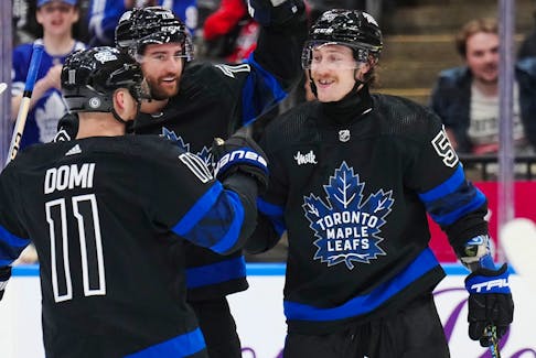 Toronto Maple Leafs left wing Tyler Bertuzzi (59) celebrates his goal against the Washington Capitals with forward Max Domi (11) and defenceman TJ Brodie (78) during second period NHL hockey action in Toronto on Thursday, March 28, 2024.