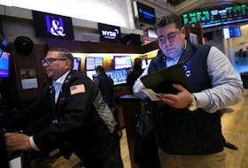 Traders work on the floor at the New York Stock Exchange (NYSE) in New York City, U.S., March 20, 2024. 