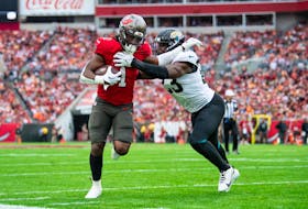 Dec 24, 2023; Tampa, Florida, USA; Tampa Bay Buccaneers running back Rachaad White (1) is tackled by Jacksonville Jaguars linebacker Foyesade Oluokun (23) in the first quarter at Raymond James Stadium. Mandatory Credit: Jeremy Reper-USA TODAY Sports/File Photo