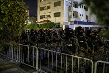 Members of the Jordanian Gendarmerie stand guard as people protest in support of Palestinians in Gaza, amid the ongoing conflict between Israel and the Palestinian Islamist group Hamas, near the Israeli embassy in Amman, Jordan, March 28, 2024.