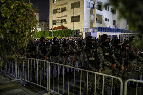 Members of the Jordanian Gendarmerie stand guard as people protest in support of Palestinians in Gaza, amid the ongoing conflict between Israel and the Palestinian Islamist group Hamas, near the Israeli embassy in Amman, Jordan, March 28, 2024.