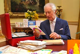 Britain's King Charles reads cards and messages, sent by well-wishers following his cancer diagnosis, in the 18th Century Room of the Belgian Suite in Buckingham Palace, London, Britain, February 21, 2024. Jonathan Brady/Pool via