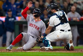 Mar 28, 2024; Seattle, Washington, USA; Boston Red Sox right fielder Tyler O'Neill (17) scores a run after a throw gets past Seattle Mariners catcher Cal Raleigh (29) during the fourth inning at T-Mobile Park. Mandatory Credit: Stephen Brashear-USA TODAY Sports
