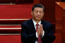 Chinese President Xi Jinping applauds at the closing session of the National People's Congress (NPC) at the Great Hall of the People in Beijing, China March 11, 2024.