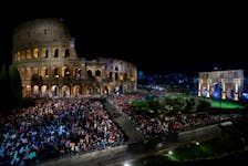 People gather outside the Colosseum, on the day Pope Francis presides over the Via Crucis (Way of the Cross) procession during Good Friday celebrations, in Rome, Italy March 29, 2024.
