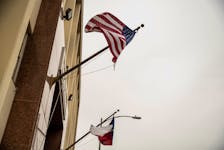 The U.S. and Texas flags wave as a court hearing is held on Texas Governor Greg Abbott's order that parents of transgender children be investigated for child abuse, in Austin, Texas, U.S. March 11, 2022. 