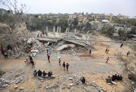 Palestinians inspect the site of an Israeli strike on a house, amid the ongoing conflict between Israel and Hamas, in Khan Younis in the southern Gaza Strip March 29, 2024.