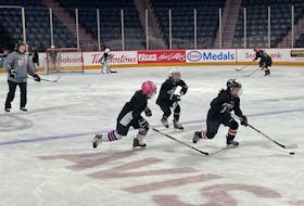 Cassie Campbell-Pascall watches as a trio of young players skate during a drill at the Scotiabank Girls HockeyFest in Halifax on Sunday. - GLENN MacDONALD / THE CHRONICLE HERALD