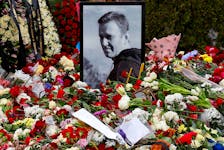 A portrait of Russian opposition politician Alexei Navalny is placed amid flowers at his grave the day after the funeral at the Borisovskoye cemetery in Moscow, Russia, March 2, 2024.