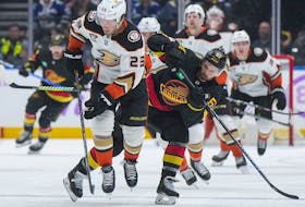 The struggling Canucks face the woeful Anaheim Ducks in a Sunday matinee. Here, Anaheim Ducks' Mason McTavish and Vancouver Canucks' Teddy Blueger vie for the puck during the second period of an NHL hockey game in Vancouver, on Tuesday, Nov. 28, 2023.
