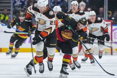 The struggling Canucks face the woeful Anaheim Ducks in a Sunday matinee. Here, Anaheim Ducks' Mason McTavish and Vancouver Canucks' Teddy Blueger vie for the puck during the second period of an NHL hockey game in Vancouver, on Tuesday, Nov. 28, 2023.