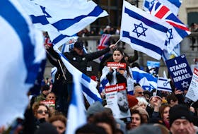 Pro-Israeli supporters waving flags gather for a demonstration in Trafalgar Square in central London on January 14, 2024, to show support for the bereaved families, families of hostages, soldiers and the people of Israel. (Photo by HENRY NICHOLLS / AFP) 