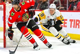 Jesse Puljujarvi of the Pittsburgh Penguins (right) pursues Seth Jones of the Chicago Blackhawks during an NHL game at the United Center on Feb. 15, 2024.