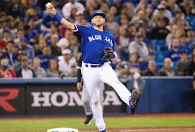 Josh Donaldson #20 of the Toronto Blue Jays throws out a baserunner.
