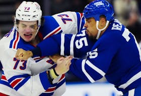 New York Rangers' Matt Rempe (73) and Toronto Maple Leafs' Ryan Reaves (75) fight.