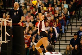 Saint Mary's Huskies' Megan Bruhm spikes a ball against the Acadia Axewomen in Game 2 of the AUS women's volleyball championship at the Homburg Centre on Sunday night. - Eduardo Ibarra / Saint Mary's Huskies