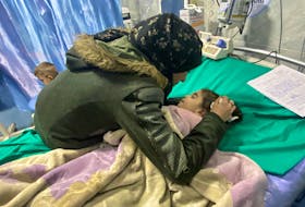 Palestinian mother Anwar Abdulnabi cries over the body of her daughter Mila, who had been suffering from deficiencies of calcium and potassium, at Kamal Adwan hospital on the edges of Beit Lahiya, in the northern Gaza Strip March 2, 2024.