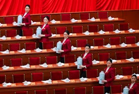 Attendents stand to serve tea on the day of the opening session of the Chinese People's Political Consultative Conference (CPPCC) at the Great Hall of the People in Beijing, China March 4, 2024.