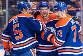 Edmonton Oilers Cody Ceci (5), Corey Perry (90) and Ryan McLeod (71) celebrate a goal against the Pittsburg Penguins in Edmonton on Sunday, March 3, 2024.