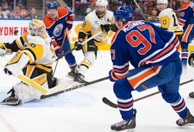 Pittsburg Penguins goalie Alex Nedeljkovic (39) makes a save on Edmonton Oilers' Connor McDavid (97) during second period NHL action in Edmonton on Sunday, March 3, 2024.