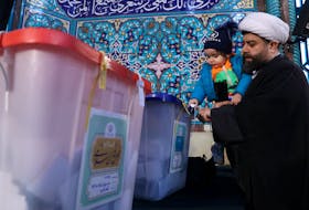 An Iranian cleric casts his vote during parliamentary elections at a polling station in Tehran, Iran, March 1, 2024. Majid Asgaripour/WANA (West Asia News Agency) via
