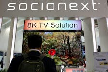 A visiter watches a 8K TV screen at Socionext booth, the Panasonic-Fujitsu SoC joint venture corporation, during the annual Computex computer exhibition in Taipei, Taiwan June 1, 2016.