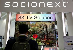 A visiter watches a 8K TV screen at Socionext booth, the Panasonic-Fujitsu SoC joint venture corporation, during the annual Computex computer exhibition in Taipei, Taiwan June 1, 2016.