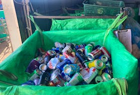 Used cans are put in a container bag before recycling at A&S Bottle Exchange, Charlottetown. Pratik Bhattarai • The Guardian