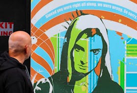 A man looks at an artwork depicting Irish singer Sinead O'Connor, who died at the age of 56, known for her chart-topping hit 'Nothing Compares 2 U', in Dublin, Ireland, July 27, 2023.