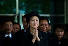 Ousted former Thai prime minister Yingluck Shinawatra greets supporters as she arrives at the Supreme Court in Bangkok, Thailand, July 21, 2017.