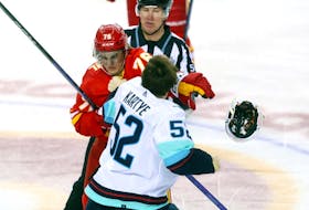 Calgary Flames Martin Pospisil battles Seattle Kraken Tye Kartye in second period NHL action at the Scotiabank Saddledome in Calgary on Monday, March 4, 2024. Darren Makowichuk/Postmedia