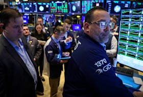 Traders work on the floor at the New York Stock Exchange (NYSE) in New York City, U.S., February 29, 2024. 