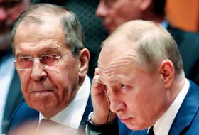 Russian President Vladimir Putin and Russia's acting Foreign Minister Sergei Lavrov attend the Libya summit in Berlin, Germany, January 19, 2020. 