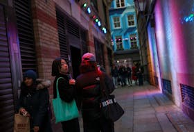 Shoppers walk along an alley by Regent Street during the Boxing Day sales, in London, Britain, December 29, 2023.