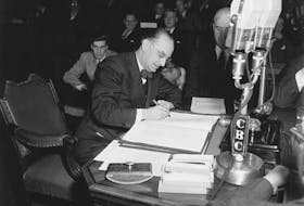 Joseph Smallwood, premier from 1949 to 1972, signs the document which entered Newfoundland into Confederation, making it Canada's tenth province.