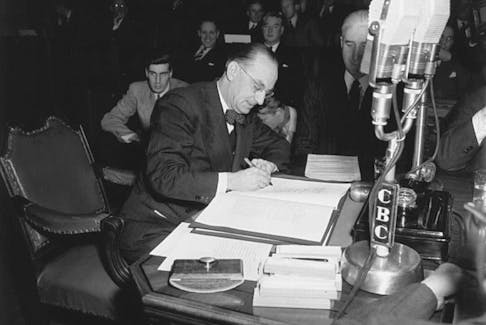 Joseph Smallwood, premier from 1949 to 1972, signs the document which entered Newfoundland into Confederation, making it Canada's tenth province.