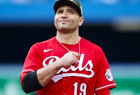Joey Votto of the Cincinnati Reds smiles during a game against the Toronto Blue Jays in 2022.