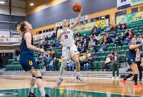Alaina McMillan of the Saint Mary's Huskies drives to the basket for a layup against the Queen's Gaels during a U Sports Final 8 women's basketball championship quarter-final Thursday night in Edmonton. - U SPORTS 