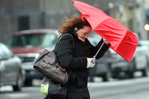 Dec. 31, 2007--A pedestrian shields herself with an umbrella as the snow turns to freezing rain around 9:30 Monday morning. The storm today is expected to bring 10 cm of snow and 5 to 10 mm of freezing rain.