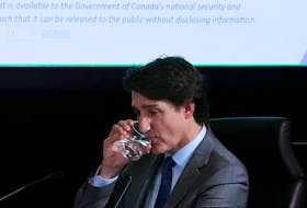 A document is displayed on a screen behind Prime Minister Justin Trudeau as he appears as a witness at the Public Inquiry Into Foreign Interference in Federal Electoral Processes and Democratic Institutions in Ottawa on Wednesday, April 10, 2024.
