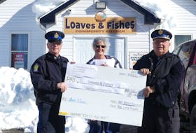 Cape Breton Regional Police Service (CBRPS) officers Const. Gary Fraser, left, and Sgt. Barry Gordon, right, present Marguerite MacDonald of Loaves and Fishes with a $1026.60 donation raised during a Food Drive held by the CBRPS on Feb. 2. The annual drive raised $2053.20 in cash donations from the public in less than five hours this year, donating half to Loaves and Fishes Community Kitchen and half to the Jane Paul Indigenous Women's Resource Centre. Sgt. Gordon says the drive saw over $4000 in food donations as well. Mitchell Ferguson/Cape Breton Post
