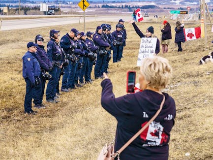 Alberta RCMP stop demonstrators from gathering on the Trans-Canada Highway near Highway 22 west of Calgary on Tuesday, April 2, 2024. 
